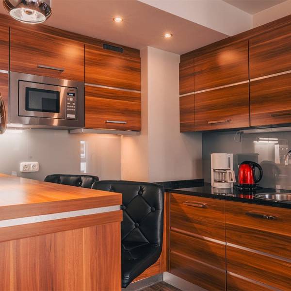 Dining area and kitchenette in the apartment at Arkona Strandresidenzen Binz with bar stools and modern design