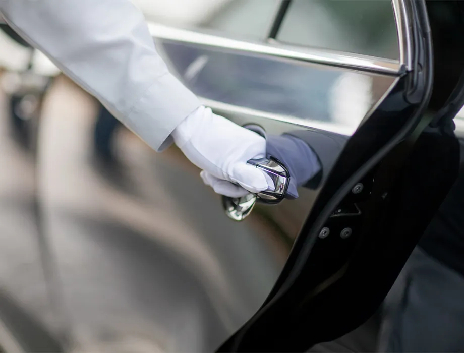 Our limousine service opens the door of one of our first-class limousines for your comfortable transportation.
