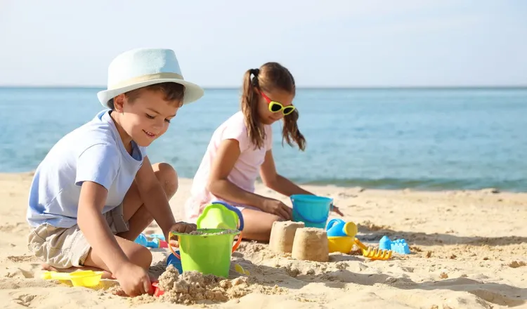 Children building sandcastles on the beach of the Baltic Sea during a summer holiday