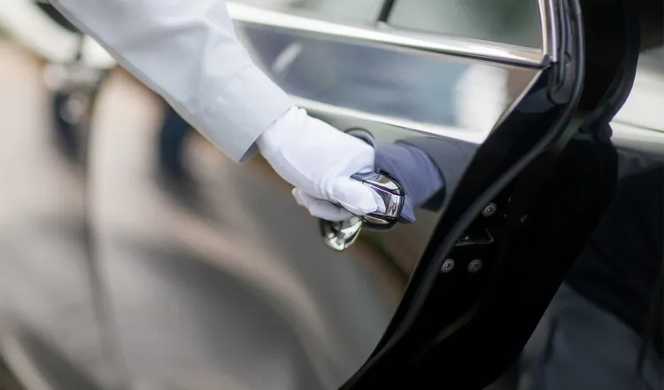 Our limousine service opens the door of one of our first-class limousines for your comfortable transportation.