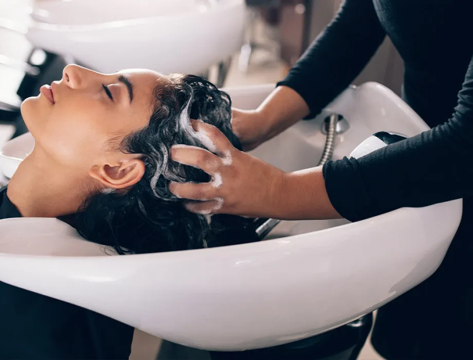 A woman enjoys a relaxing head massage while washing her hair at the Figaro hairdresser on the island of Rügen.