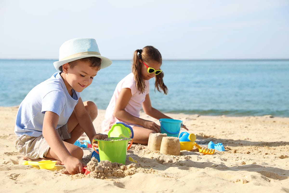 Children building sandcastles on the beach of the Baltic Sea during a summer holiday