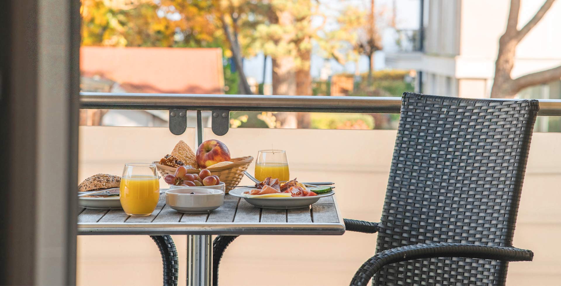Fresh breakfast with juice, rolls and fruit on the balcony of Arkona Strandresidenzen during Baltic Sea holiday in Binz